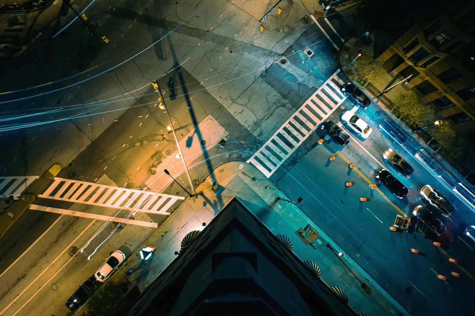 Looking down onto city streets at night from a rooftop
