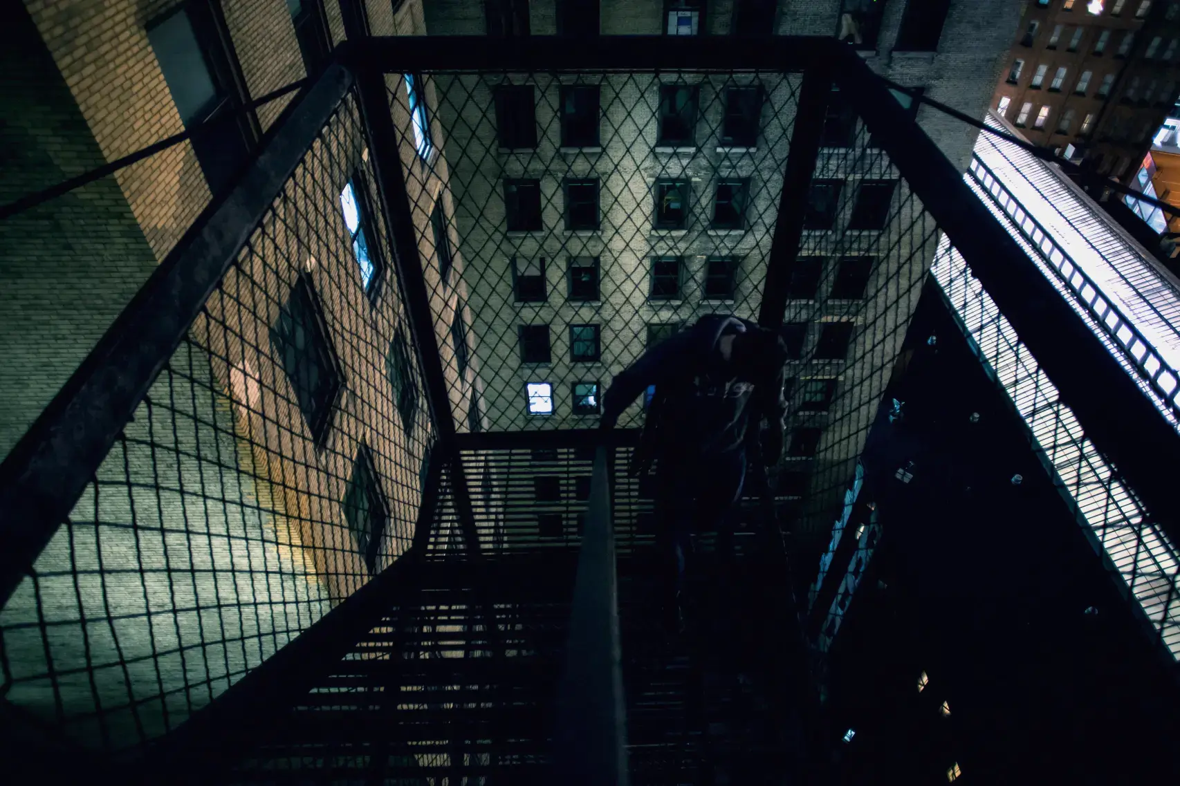 Taking the fire escape down from the roof of a building after doing night photography