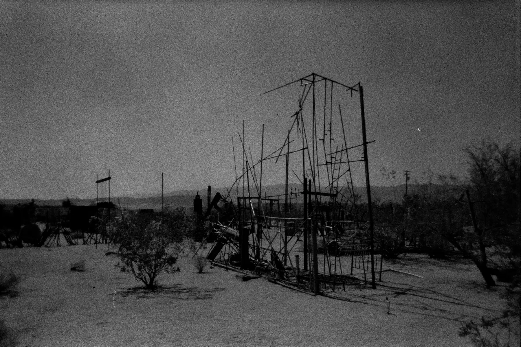 Black and white 35mm photo of structures in the desert