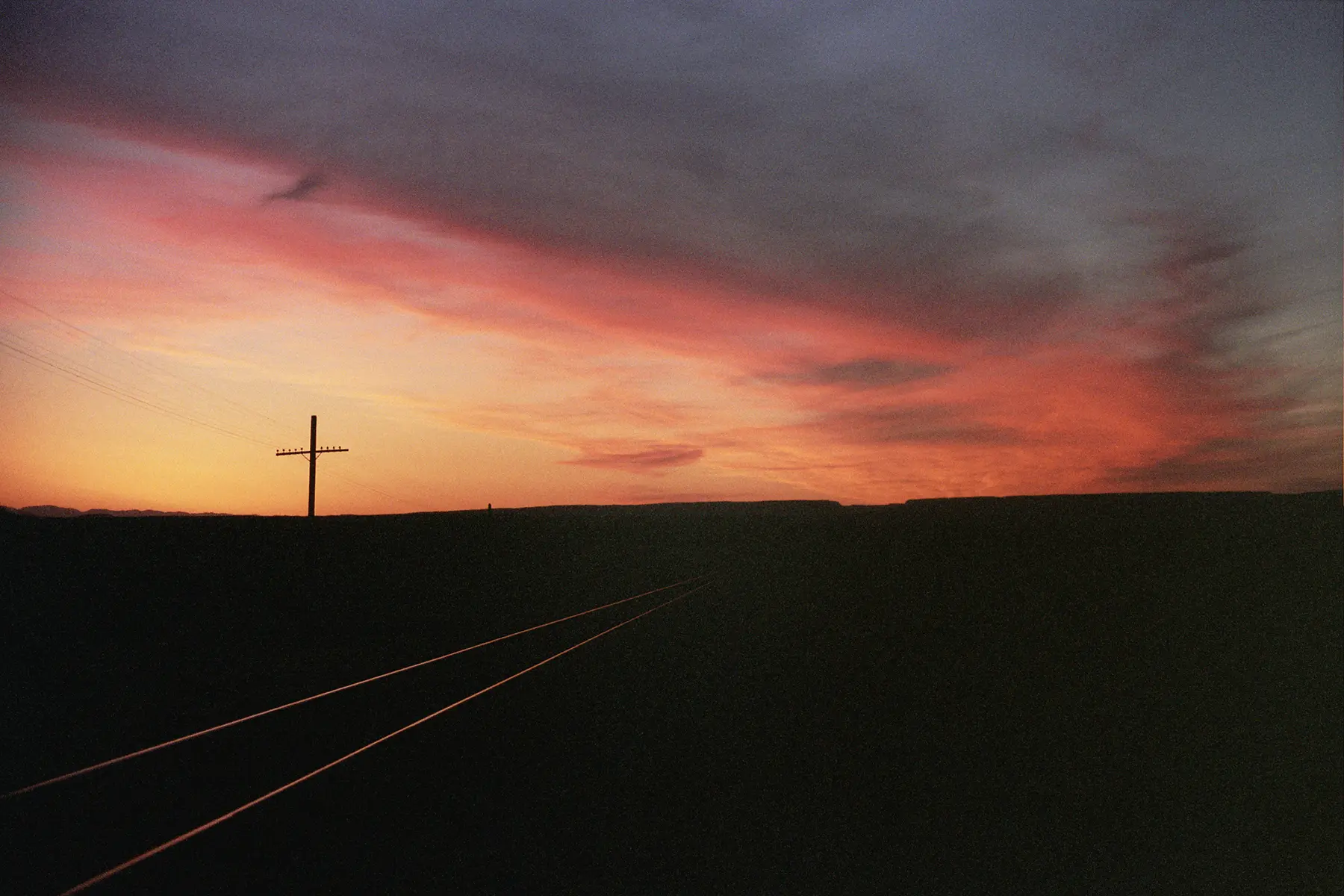25mm sunset photo looking down train tracks outside of Cisco, Utah